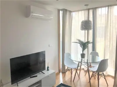 a living room with a tv and a table and chairs at Oporto Yellow Apartments in Porto