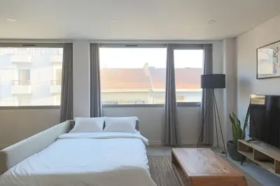 a bedroom with a bed and a large window at Marquês Deluxe Apartments 3 & 4 in Porto