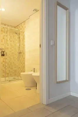 a bathroom with a shower and a toilet and a sink at Marquês Deluxe Apartments 3 & 4 in Porto