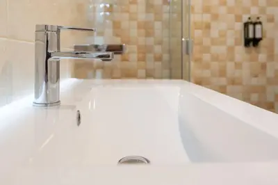 a white sink with a faucet in a bathroom at Marquês Deluxe Apartments 3 & 4 in Porto