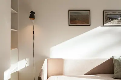 a living room with a couch and a floor lamp at VIVA Whilom Secret with garage in Porto