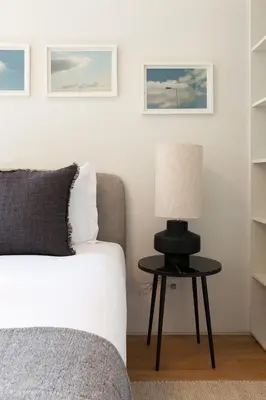 a bedroom with a bed and a table with a lamp at VIVA Whilom Secret with garage in Porto