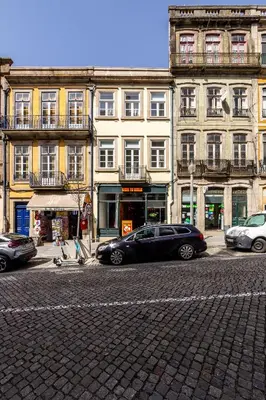 a black car parked in front of a building at Mouzinho 129 - Medronheiro & Oliveira in Porto