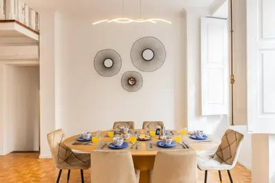 a dining room with a table and chairs at São Bento Deluxe 42 with Balcony in Porto
