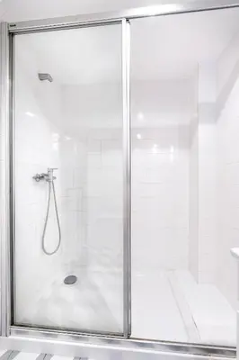 a shower with a glass door in a bathroom at VIVA Library Studio in Porto