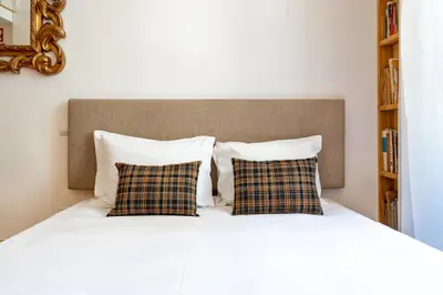 a bed with two pillows and a headboard at VIVA Library Studio in Porto