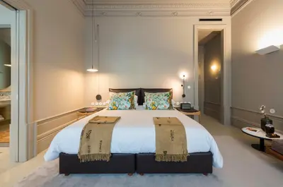 a hotel room with a bed and a table at Jardins do Porto - by Unlock Hotels in Porto
