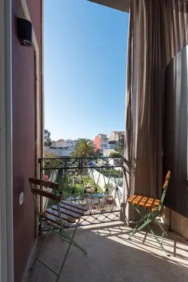 a living room with a couch with pillows at Jardins do Porto - by Unlock Hotels in Porto