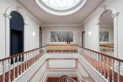 a waiting room with a couch and tables and mirrors at Jardins do Porto - by Unlock Hotels in Porto