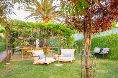 a bedroom with a bed with a night stand next to it at Jardins do Porto - by Unlock Hotels in Porto