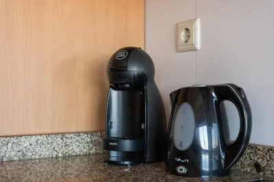 a coffee maker sitting on a counter next to a coffee pot at GuestReady - Warwick avenue in Lapa in Porto