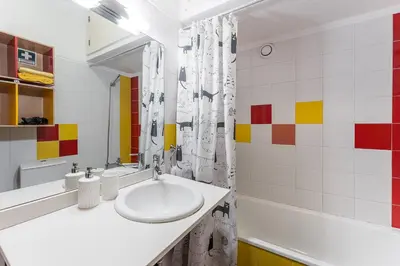 a white bathroom with a sink and a tub at GuestReady - Warwick avenue in Lapa in Porto