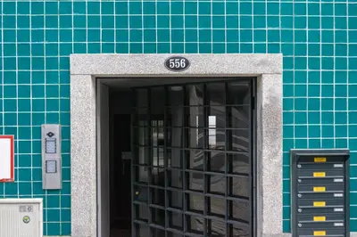 a door to a building with a sign on it at N&N Home in Porto