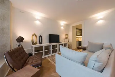a living room with a couch and a tv at Classy & Stylish Porto Duplex in Porto