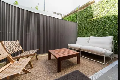 a patio with a bench and a couch and a table at Classy & Stylish Porto Duplex in Porto
