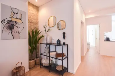 a hallway with two mirrors and a shelf with items at Oporto lovely house deluxe in Porto