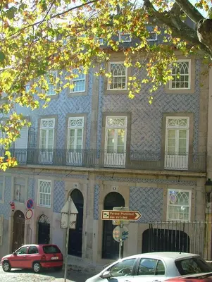 a blue and white building with cars parked in front of it at Citybreak-apartments Douro View in Porto