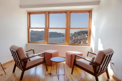 a room with three chairs and a table and a window at Citybreak-apartments Douro View in Porto
