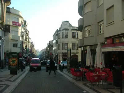 a city street with tables and chairs and buildings at Citybreak-apartments Bolhao in Porto