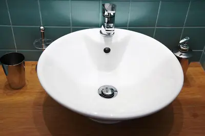 a white sink in a bathroom with green tiles at Citybreak-apartments Bolhao in Porto
