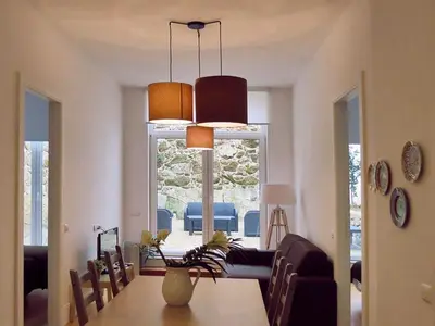 a living room with a table and a dining room at Citybreak-apartments Bolhao in Porto