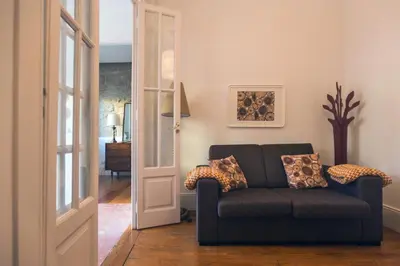 a living room with a couch and a door at Citybreak-apartments Bolhao in Porto