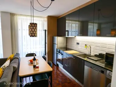 a kitchen with a couch and a table in a room at rosario inn porto in Porto