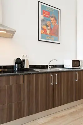 a kitchen with a sink and a picture on the wall at Porto Legend Apartments in Porto