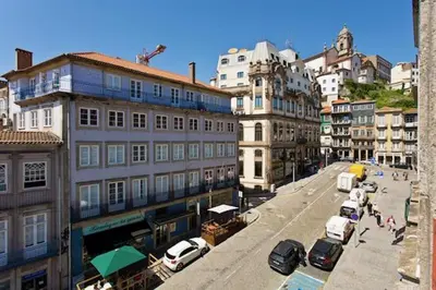 a city street with buildings and cars parked on the street at Porto Legend Apartments in Porto