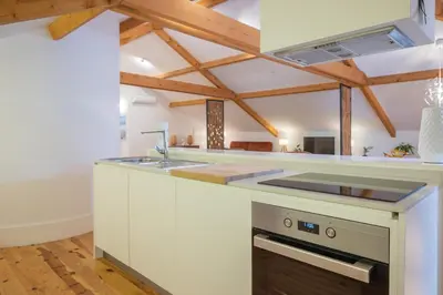 a kitchen with a white counter top and a sink at Tomas Loft in Porto