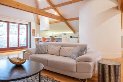 a living room with a couch and a table at Tomas Loft in Porto