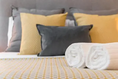 a bed with a pile of towels on it at GuestReady - Chakra Duplex in Porto