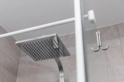 a shower seat in a bathroom with a glass door at GuestReady - Chakra Duplex in Porto