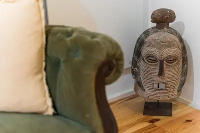 a statue of a head sitting next to a couch at GuestReady - Riber Porto Apts in Porto