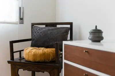 a pumpkin sitting on a chair next to a dresser at GuestReady - Riber Porto Apts in Porto