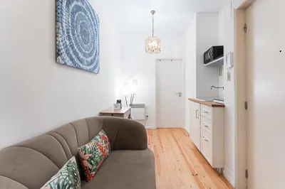 a living room with a couch and a kitchen at GuestReady - Riber Porto Apts in Porto