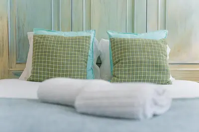 a bed with two pillows and a white blanket at GuestReady - Riber Porto Apts in Porto