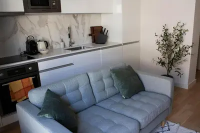 a living room with a couch in a kitchen at Casa do Paraiso - City Center Gem (w/ AC) by LovelyStay in Porto
