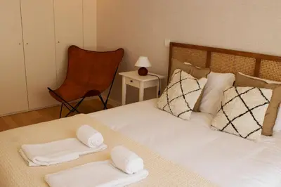 a bedroom with a bed with two towels on it at Casa do Paraiso - City Center Gem (w/ AC) by LovelyStay in Porto