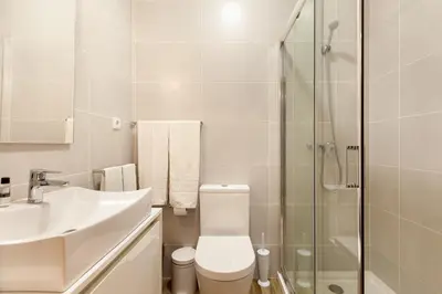 a bathroom with a toilet and a sink and a shower at D&S - Alegria 630 in Porto