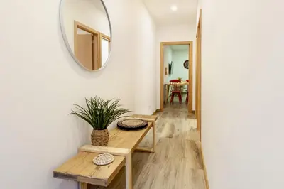 a living room with a table and a mirror at D&S - Alegria 630 in Porto