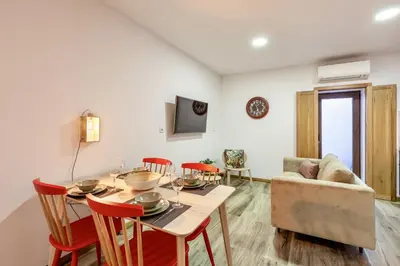 a dining room with a table and chairs and a couch at D&S - Alegria 630 in Porto