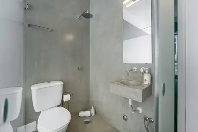 a bathroom with a toilet and a sink at GuestReady - Gold Leaf in Porto