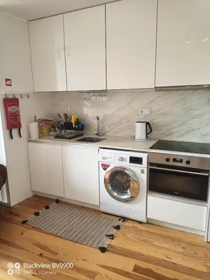 a kitchen with a washing machine and a stove at Oporto Apartment Sé Catedral in Porto