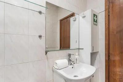 a white bathroom with a sink and a mirror at GuestReady - Final Step in Porto