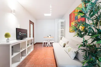 a living room with a couch and a tv at GuestReady - Final Step in Porto