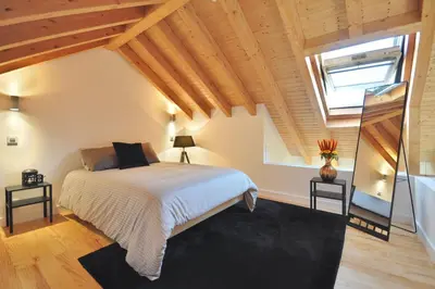 a bedroom with a large bed and a window at Sé do Porto - Loft with City View in Porto