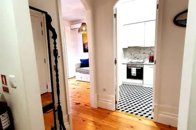 a hallway with a doorway to a kitchen with a stove at OHH - General da Silveira Flat Deluxe Apartment - Downtown in Porto