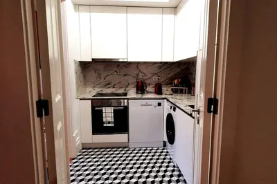 a kitchen with a black and white tiled floor at OHH - General da Silveira Flat Deluxe Apartment - Downtown in Porto