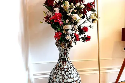 a silver vase with red and white flowers in it at OHH - General da Silveira Flat Deluxe Apartment - Downtown in Porto